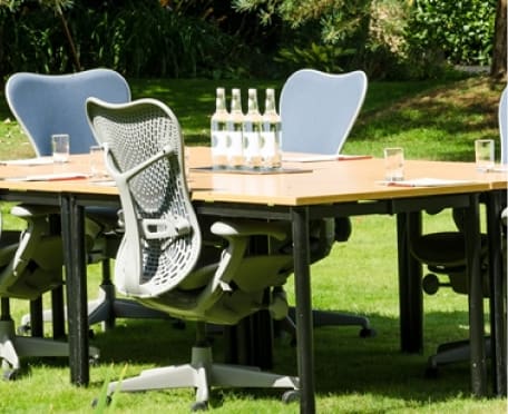 Outdoor corporate table and chairs with water bottles and glasses at Guyers House Hotel