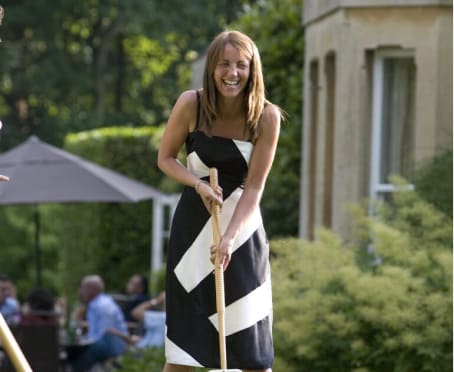 Lady holding croquet club in gardens of Guyers House Hotel