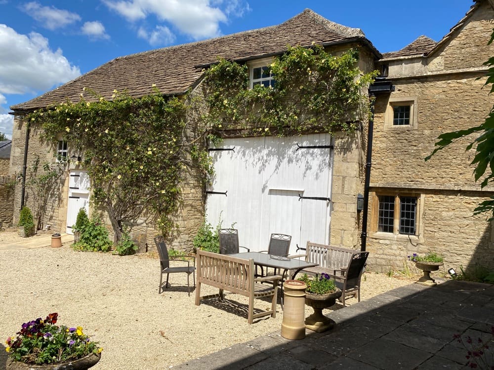 Outdoor dining area and main country house at Guyers House Hotel & Restaurant