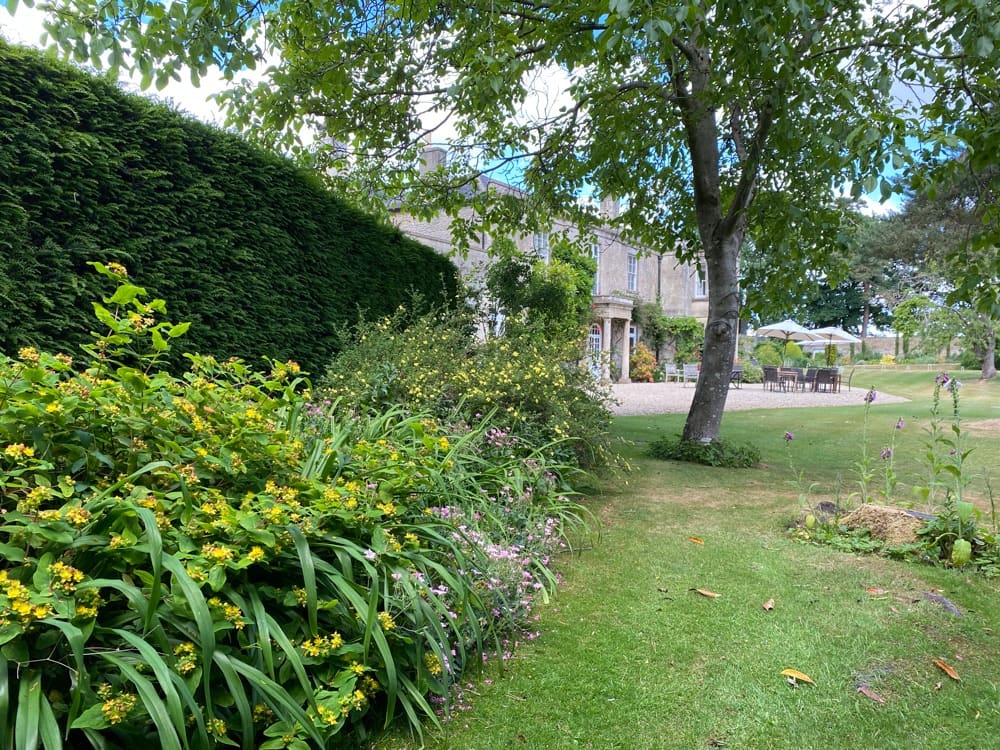 Gardens, outdoor dining area and main country house at Guyers House Hotel & Restaurant